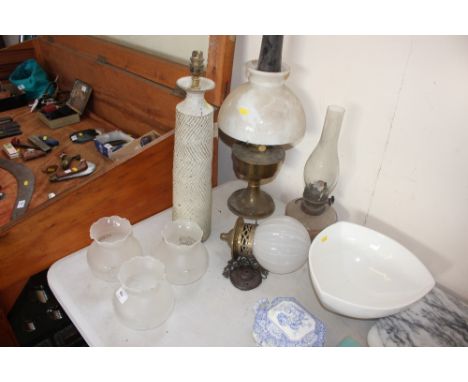 A pottery table lamp lacking lead; oil lamp with milk glass shade; hanging light; three frosted glass shades etc