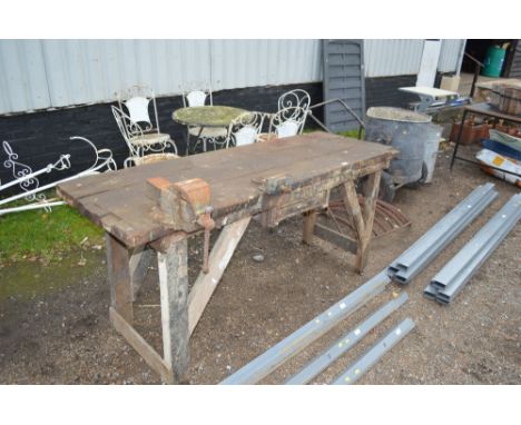 A pine work bench with two fitted vices