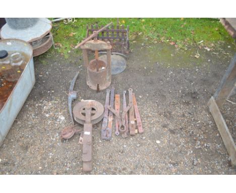 A quantity of metal items to include a pick axe head; a cast iron pulley; door brackets; a press etc