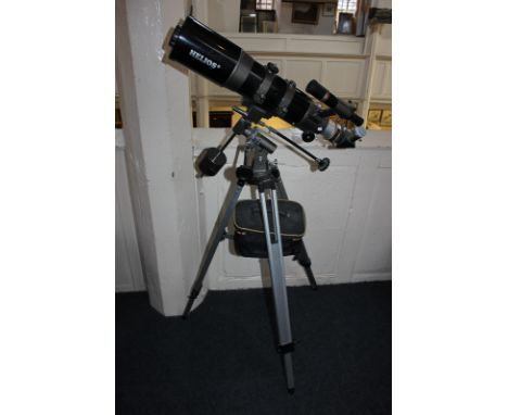 A Helios Sky-Watcher telescope with label D=102mm, F=500mm, on tripod stand with accessories and instruction leaflet