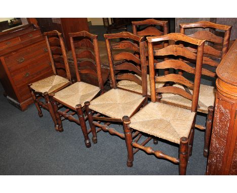 A set of six ladder back dining chairs with rush seats, turned legs and stretcher