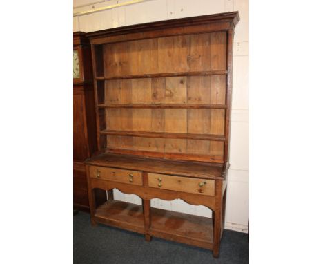 A George III oak dresser with three shelves and planked pine back, on base with two drawers, on square supports with pot boar