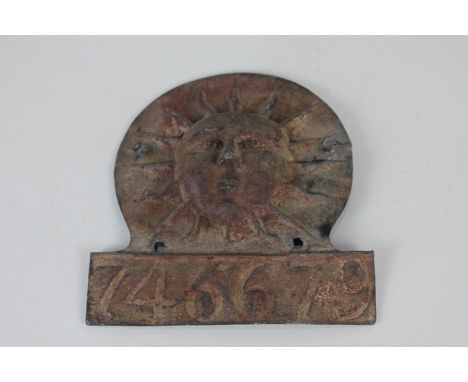 A Sun Fire Insurance lead sign cast in light relief with a sun and numbered 746679, 17cm by 16cm