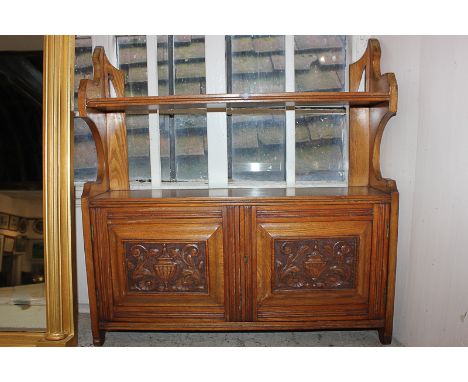 A Victorian hanging wall shelf unit with shelf above two carved panel doors enclosing cupboard, 59cm