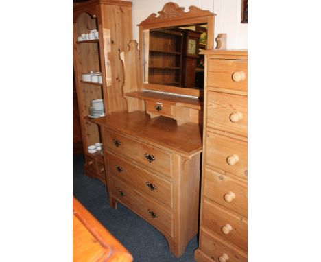 An Edwardian type dressing chest with carved surmount, adjustable mirror, shelf and jewellery drawer, above three long drawer