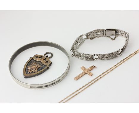 A 9ct gold cross pendant, a gold neck chain, a silver bracelet, a prize pendant, and a metal bangle