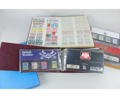 A collection of British stamps, presentation packs and first day covers in four albums