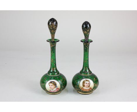 A pair of 19th century Bohemian gilt overlaid emerald glass perfume bottles and stoppers, of baluster form with slender flute