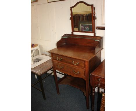 An Edwardian mahogany dressing table by Marsh Jones &amp; Cribb Ltd, with shield shape mirror above two long drawers, on squa