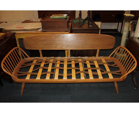 An Ercol three-seat settee with panel back and spindle arms (a/f)