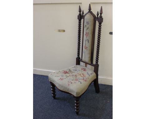 A Victorian tapestry seated nursing chair, the upholstered panel back with bobbin turned supports and pointed finials