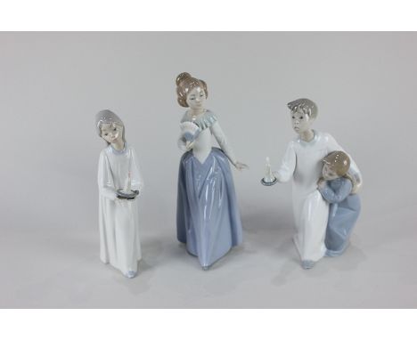 Two Lladro porcelain figures of children in night dresses with candles, and a Nao porcelain figure of a woman with a fan, 23c