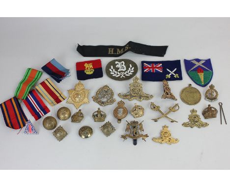 A collection of military cap badges including The Queen's Lancers, Army Catering Corps, and Royal Military Police, buttons, f