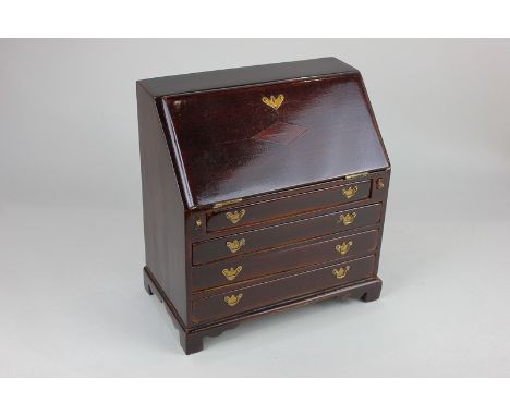 A miniature stained wooden model of a bureau with fall enclosing fitted interior of pigeon holes and small drawers, above fou