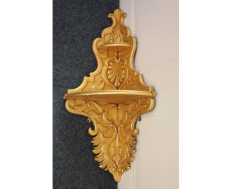 A Rococo style carved and gilded wood corner shelf, 34cm wide