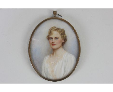 A 19th / early 20th century portrait miniature on ivory of a lady with long curled hair, wearing a white dress, indistinctly 