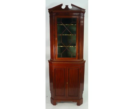 EDWARDIAN LINE INLAID MAHOGANY TWO PART FLOOR STANDING CORNER CUPBOARD, the break arch pediment above a flame cut frieze and 