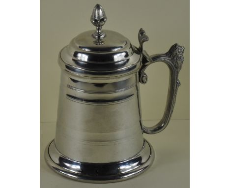 A George III style tankard with hinged lid with pineapple finial & scroll lion decorated handle, H20cm 