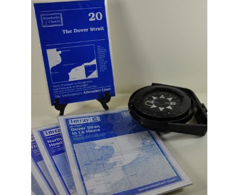 A compass together with shipping charts
