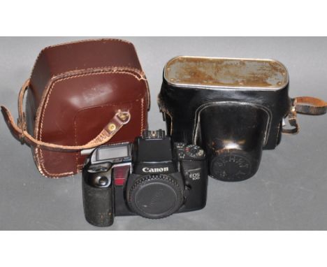 A Canon EOS 100 camera body, together with a Zenit SLR camera and a cine camera