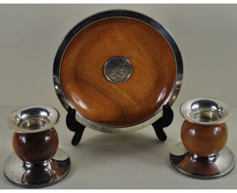 A treen and solid silver bowl with inset silver coin dated 1748 together with a pair of treen and solid silver candlesticks o