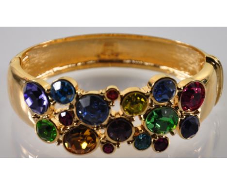 A costume jewellery bangle, gilt and set with multi-coloured stones.