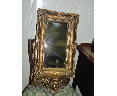A 19th century style rectangular gilt framed mirror with cherub bracket support. H 73cm W 33cm