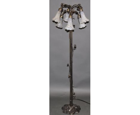 A bronzed standard lamp, in the form of a long-stemmed plant, the six mottled glass shades modelled as flower heads, H. 147cm