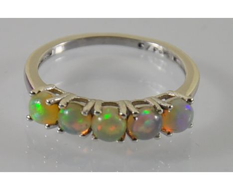 A 9ct white gold fiery opal half eternity dress ring