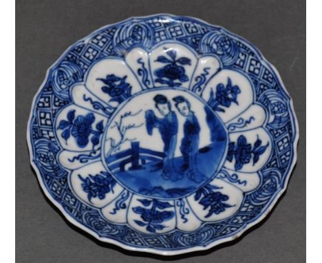 A Chinese late 17th/early 18th century Kangxi period miniature scalloped shape blue and white dish, having a centred panel of