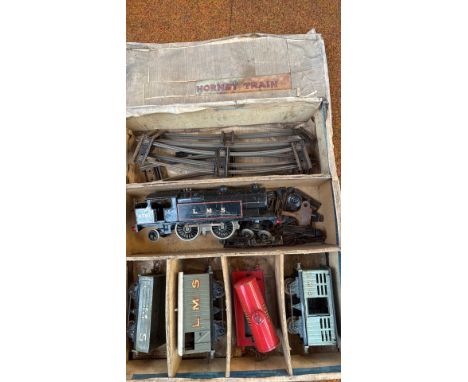 Vintage Hornby LMS tinplate train set from the mid-20th century, including locomotive 6781, freight wagons, Shell tanker, and
