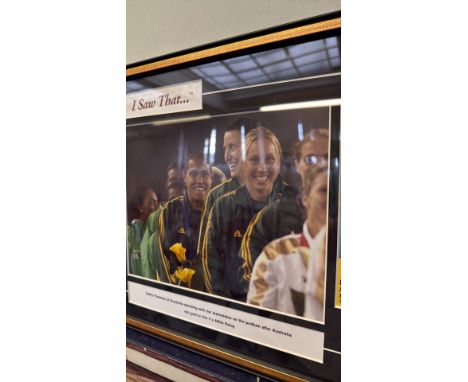 Framed memorabilia features a photograph of Cathy Freeman and teammates winning gold at the 2002 Commonwealth Games, an event