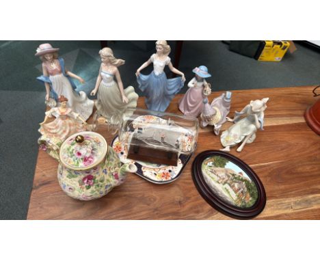 Mixed lot featuring fine porcelain figurines, floral-patterned teapot, ship-in-a-bottle model, decorative plate, and framed 3