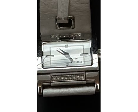 Festina wristwatch features a rectangular dial, silver-tone case, and crystal accents. The strap is white leather with decora
