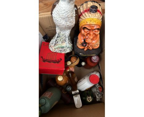 Vintage liquor bottle collection, including ceramic decanters and assorted miniature bottles. Highlighting Larsen Cognac, Lan