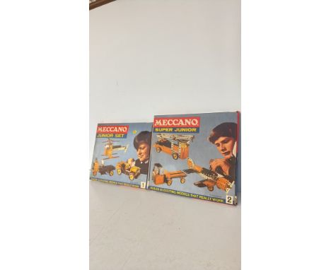 Vintage Meccano Junior and Super Junior construction sets, printed in England. Includes original packaging, offering 24 and 4