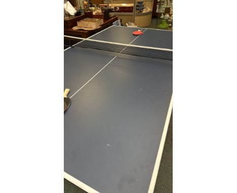 Donnay folding table tennis table with net, paddles, and balls. Features a sturdy metal frame with a smooth playing surface, 