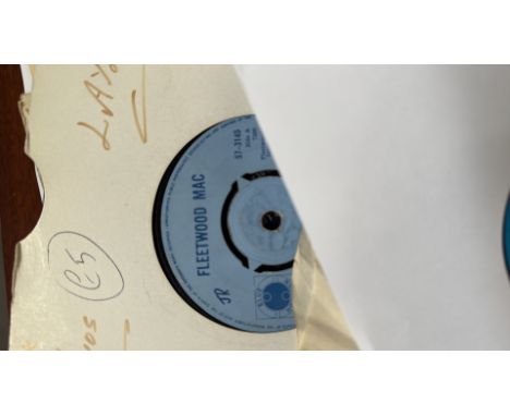 Vintage vinyl record lot featuring 7-inch singles and EPs, including Fleetwood Mac, The Kinks, and Derek and the Dominos.