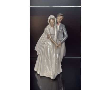NAO by Lladro porcelain figurine, "Wedding Couple," featuring a bride and groom in elegant attire. Made in Spain with a gloss