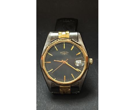 Vintage Rotary wristwatch with gold-tone and stainless steel case, black dial, and date display. Classic design with elegant 