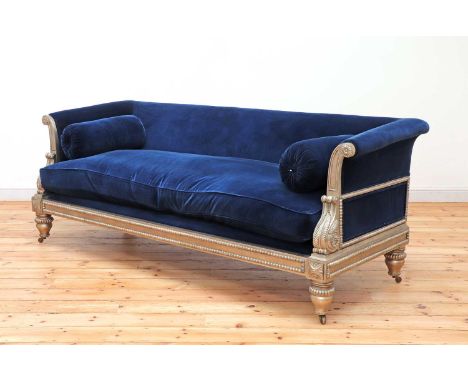 A modern Regency-style sofa,by Julian Chichester, upholstered in blue velvet, the silvered frame with carved beading and acan