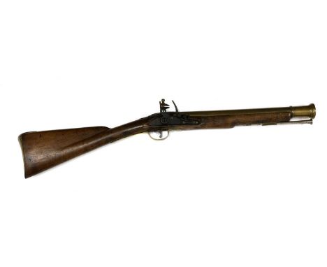 A flintlock brass-barrelled blunderbuss, of military type, the two-stage barrel with a flared and ring turned muzzle, the fla