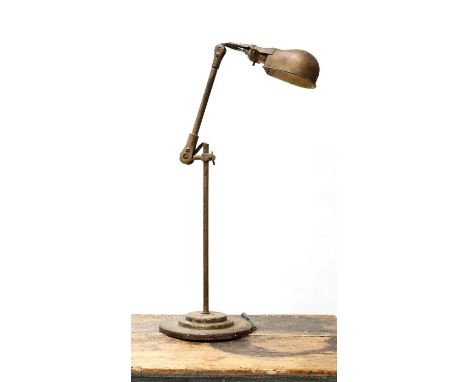 An industrial painted metal machinist's lamp, mid-20th century, with an adjustable arm and column, on a stepped circular base