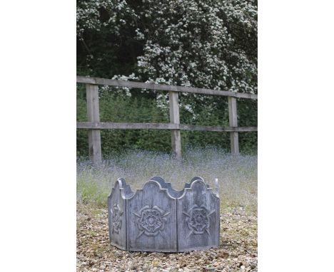A lead garden planter,20th century, each of the seven sides with a shaped edge and decorated with a Tudor rose,62cm diameter3