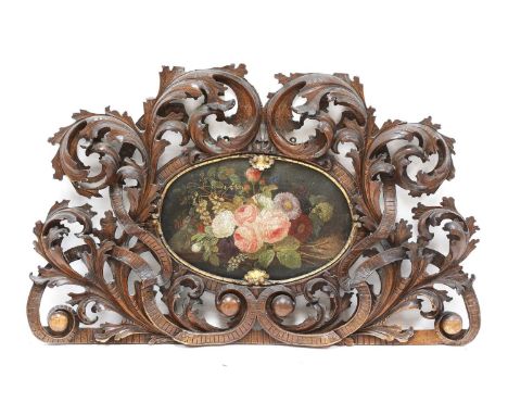 An ornately pierced and carved headboard, 19th century, Italian, decorated all-over with scrolling acanthus leaves and set wi