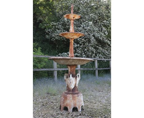 A Victorian-style painted cast iron fountain,  20th century, with three graduated gadrooned basins supported by a fluted colu