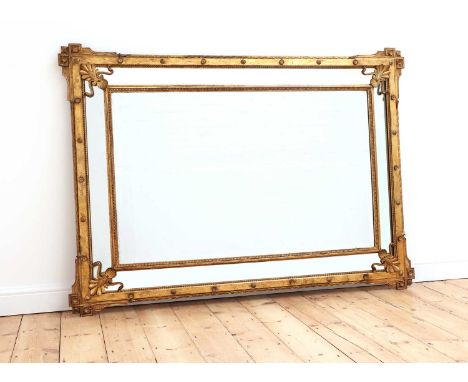 A giltwood mirror, late 19th/early 20th century, the central bevelled plate within a mirrored slip, set with anthemion spandr