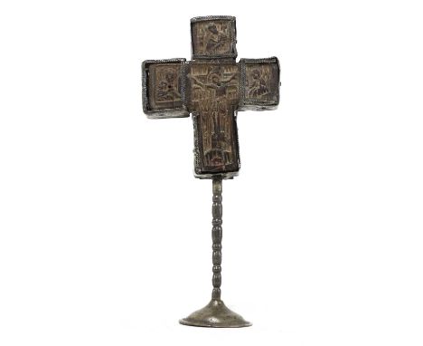 A carved olivewood Mount Athos crucifix,  16th century and later, Greek, with engraved tin mounts on a tin foot, the central 