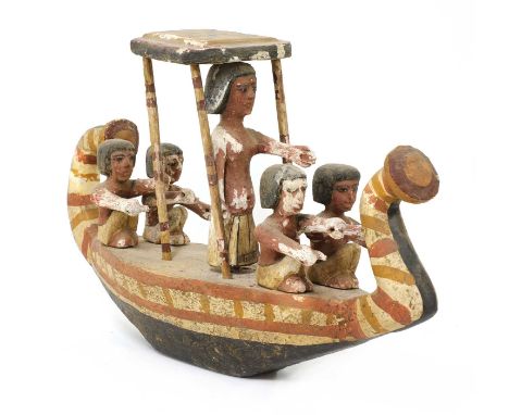 An Ancient Egyptian carved and painted wooden boat, with five figures,54cm long 34cm highCondition report: Paint flaking, los