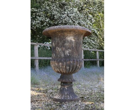 A cast iron campana garden urn,  20th century, the egg and dart detailed rim above a relief-cast body decorated with a figura